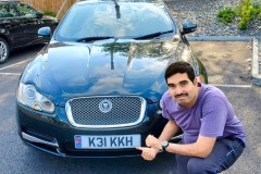 Kae Kae posing in front of his Jaguar XF